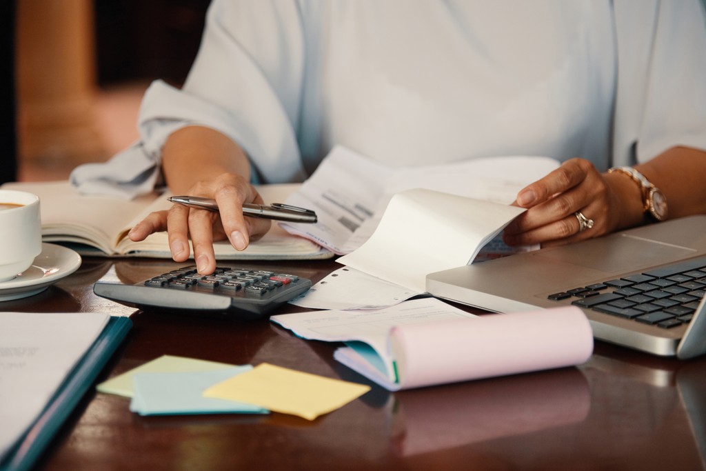 Reviewing paperwork with a calculator