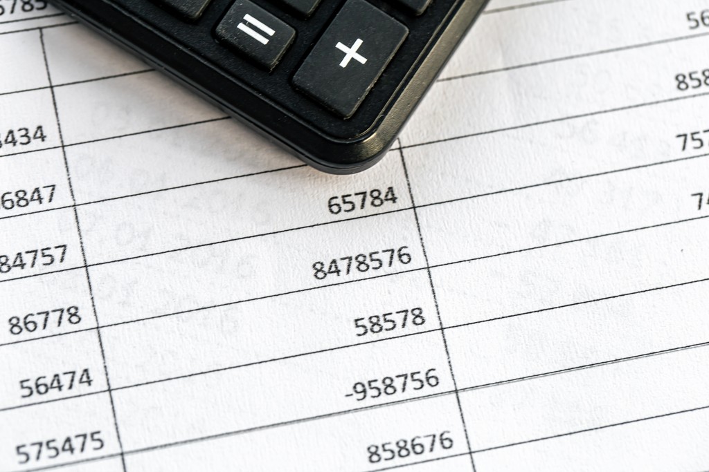 Calculator resting on a printed ledger